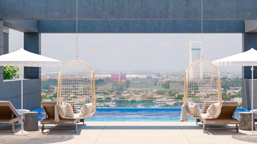 Poolside Rooftop with Two Wicker Hanging Chairs, Lounge Chairs, and White Umbrellas Overlooking a Distant Cityscape. - Apoyo Regio