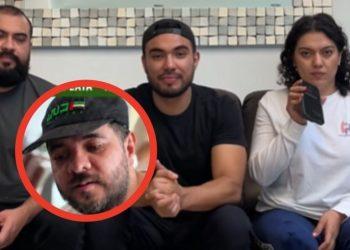 Four people sit on a couch; a man in a cap circled in red in the foreground looks down. A man in black and a woman in white sit behind him.