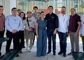 Group of Eleven Adults Standing Together Outdoors, Posing for a Casual Team Photo Under a Pavilion. - Apoyo Regio