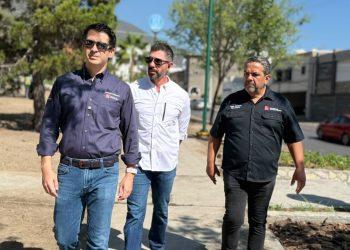 Three men wearing button-down shirts walk on a sunny sidewalk, looking ahead with serious expressions.